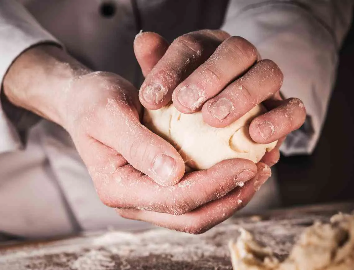 hands making a bread roll