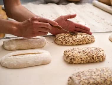 Pearson making a cut on a bread dough