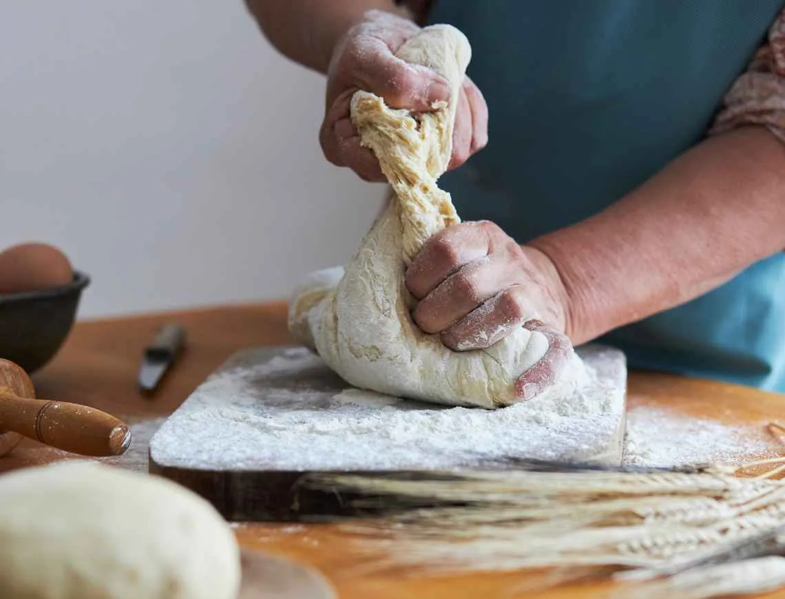 Woman kneading a fresh pasta dough